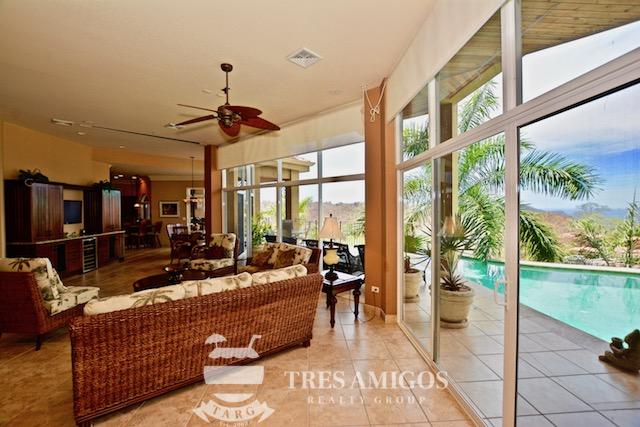 the main floor is the living room with access from inside and patio/pool from outside