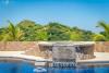 A pool with a Jacuzzi with waterfall